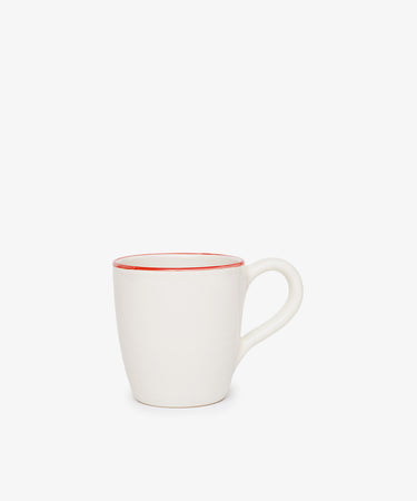 The Guido Mug is a white ceramic breakfast cup with a curved handle and a thin red line around the rim, shown on a plain white background.