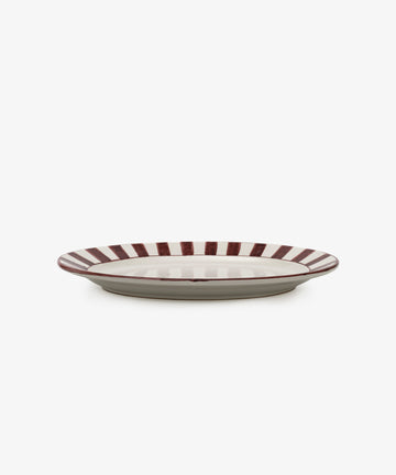 The Julius Oval Serving Platter features a white center with bold, hand-painted maroon stripes around the rim, displayed against a white background.