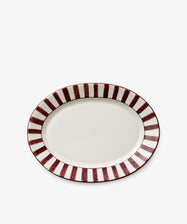 The Julius Oval Serving Platter features a white center with a bold maroon stripe along the rim, shown on a plain white background.