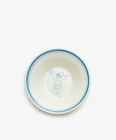 The Folk Pasta Bowl, Jester is a hand-glazed white ceramic bowl with a blue rim, featuring a simple blue line drawing of a dancing figure in the center—an elegant piece of Italian tableware.