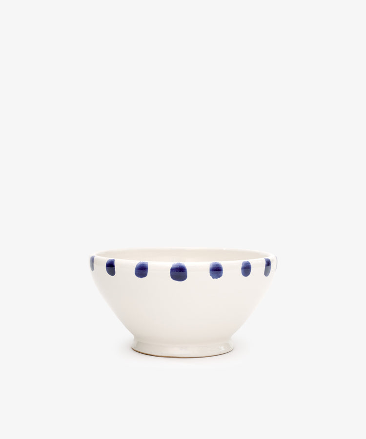 The Nina Bowl, Set of 4, features white ceramic with a richly dotted blue rim and looks stunning alongside the matching small plate and platter.