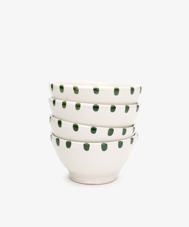 A set of four white ceramic Nina Bowls with green polka dot patterns and a matching small plate, displayed against a plain white background.