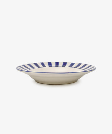 The Julius Serving Platter is a hand-painted dish with a wide rim adorned with blue and white vertical stripes, shown on a white background.