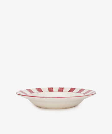 The Julius Serving Platter is a shallow, cream-colored ceramic bowl featuring bold red vertical stripes around the rim, shown on a white background.