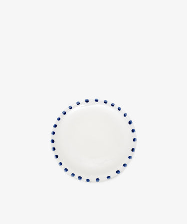 Nina Small Plate by Enza Fasano. White glazed ceramic plate with blue painted rim details.