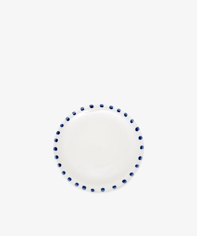 Nina Small Plate by Enza Fasano. White glazed ceramic plate with blue painted rim details.