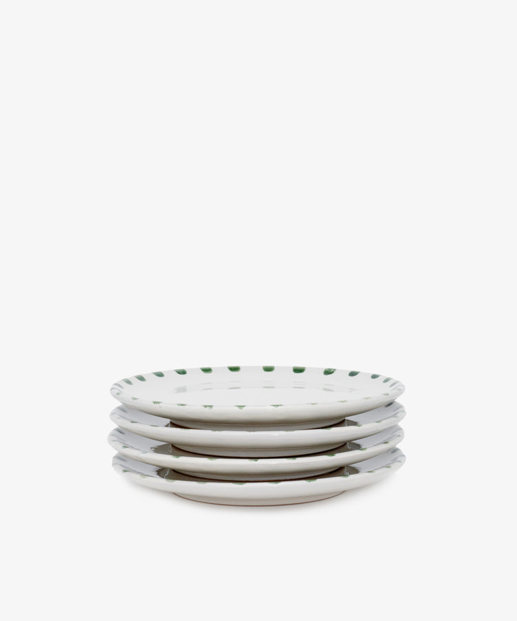 A set of four Nina Small Plates, each hand-glazed with a green dotted rim, displayed against a plain white background.