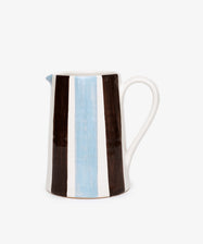 The Mina Jug is a hand-painted Italian pitcher with a handle, featuring vertical brown, white, and light blue stripes on a crisp white background.