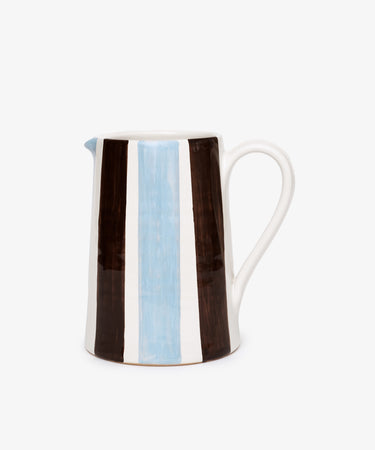 The Mina Jug is a hand-painted Italian pitcher with a handle, featuring vertical brown, white, and light blue stripes on a crisp white background.