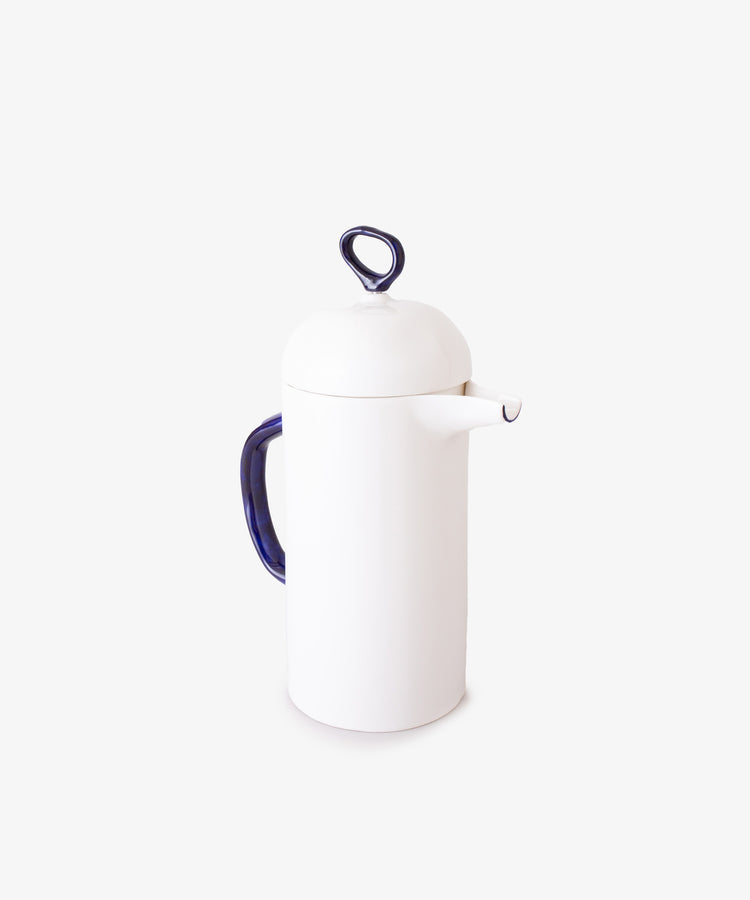 The Cafetière is a white bone china coffee pot with a blue handle and matching lid featuring a looped knob, perfect for elevating your daily coffee ritual. Shown against a plain white background.