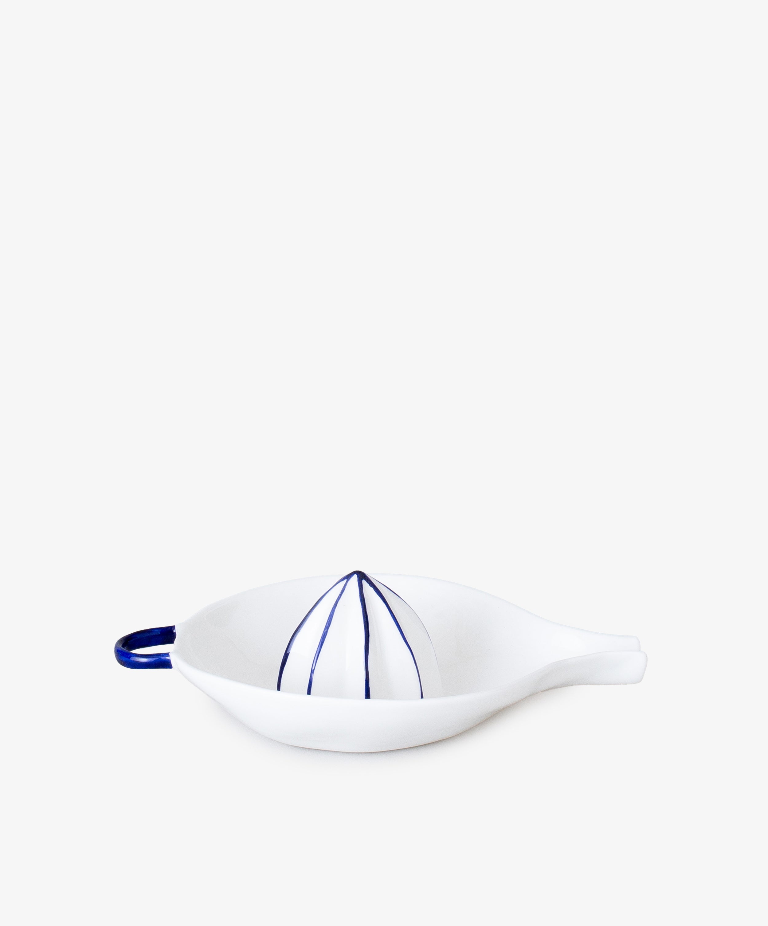 Juicer by Feldspar. White china hand-held citrus squeezer with painted blue accents, alt side view.