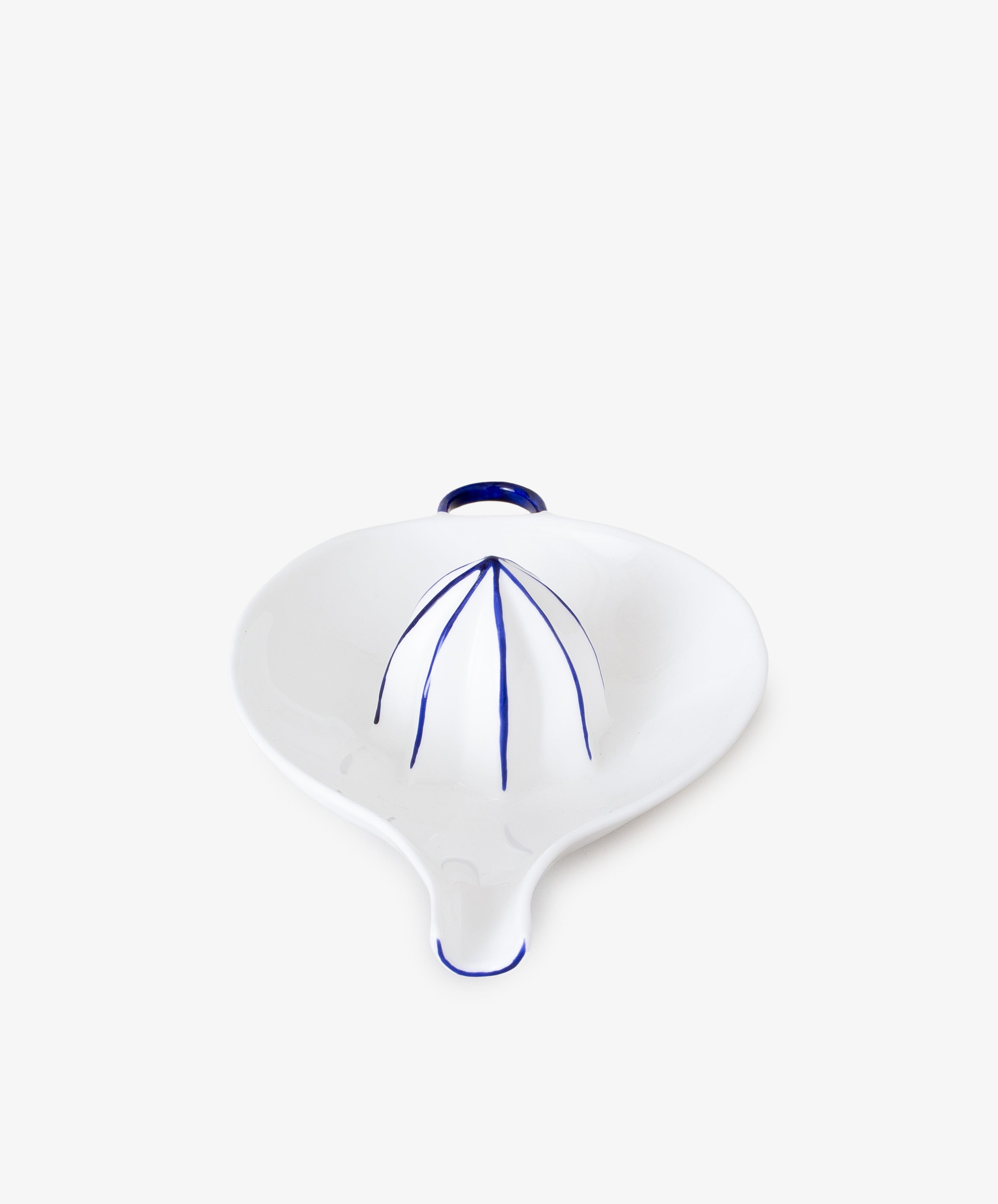 Juicer by Feldspar. White china hand-held citrus squeezer with painted blue accents, front angled view.