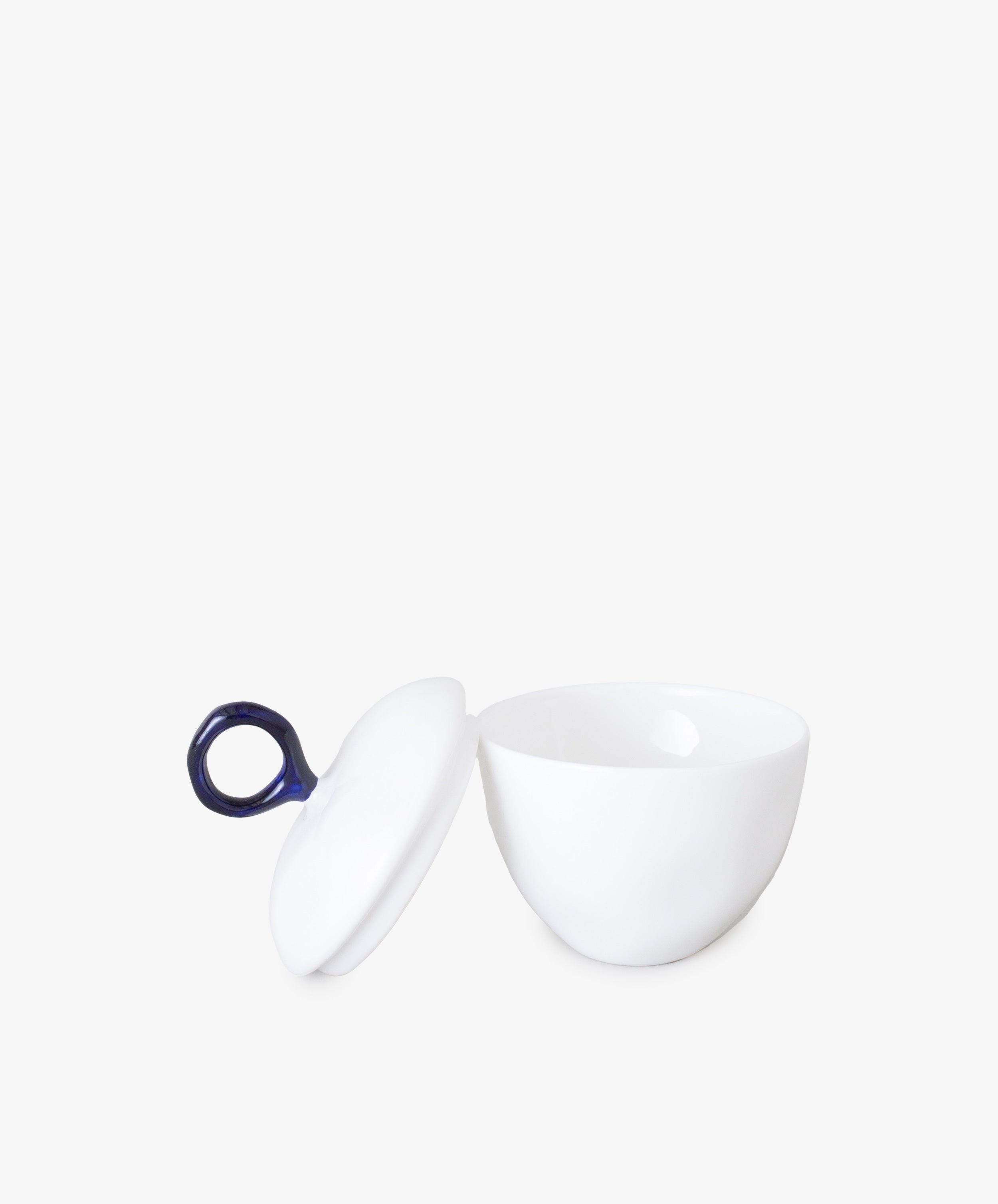 Sugarpot with Lid by Feldspar. White china pot with open lid and blue circular handle.