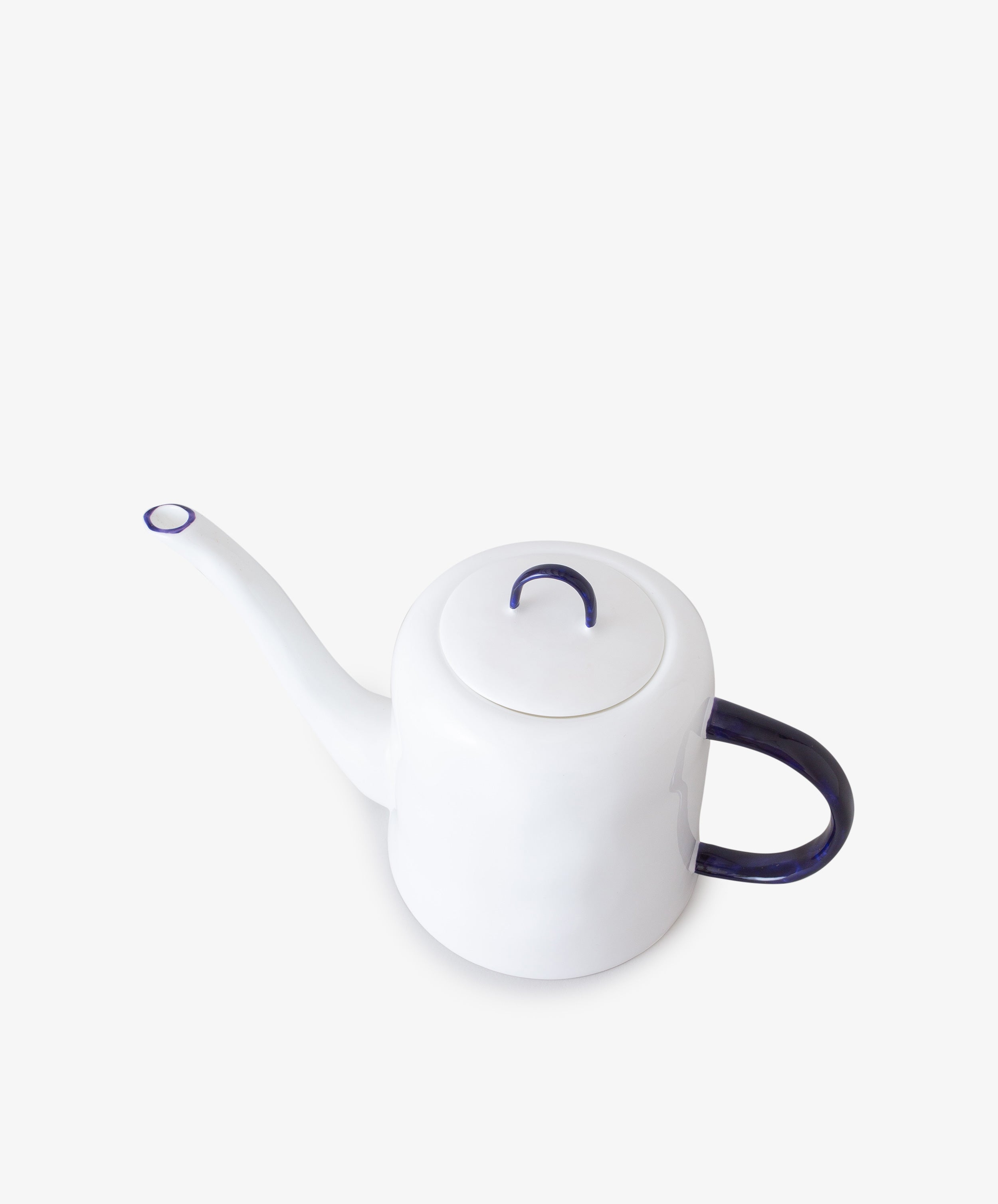 Teapot by Feldspar. White china pot with cobalt blue painted handle and long, thin spout, overhead view.