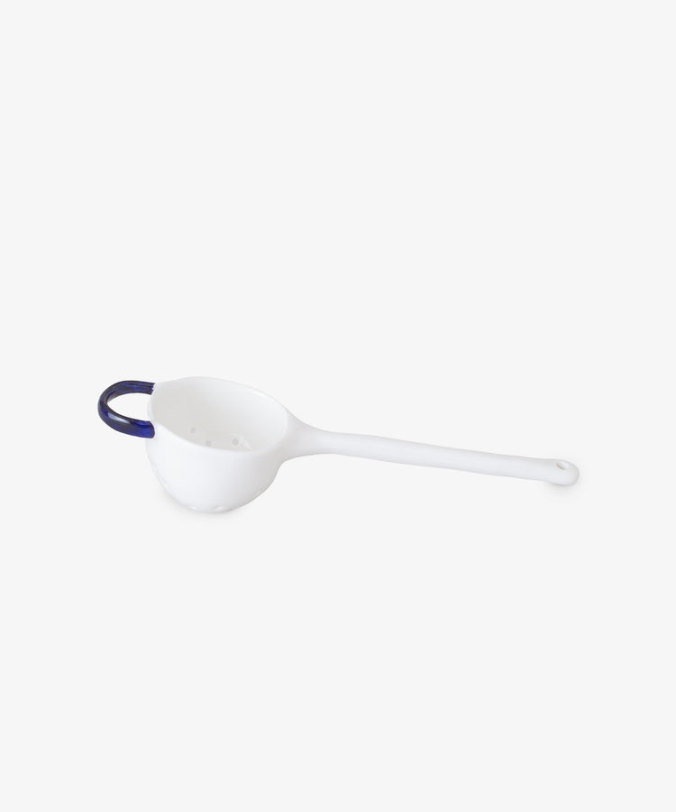 Tea Strainer by Feldspar. White china strainer with cobalt blue painted handle.