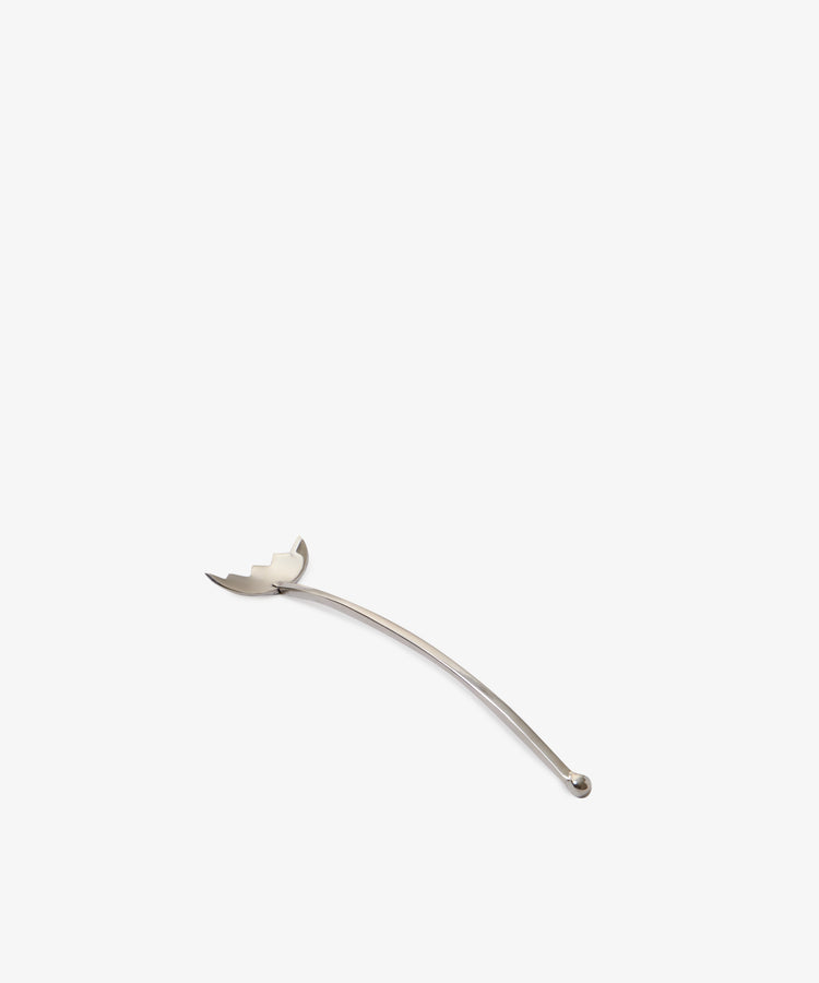 The Tinned Fish Fork, featuring a curved handle and pronged, rounded end, is set against a plain white background—an understated yet elegant utensil reminiscent of jewelry for the table.