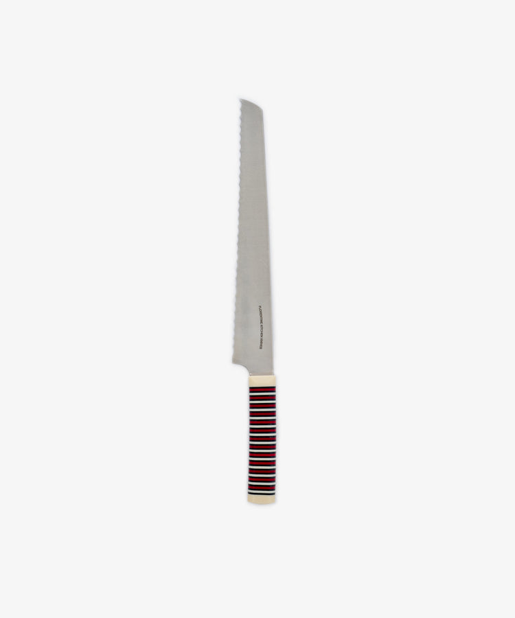 The Bread Knife features a long, serrated blade ideal for slicing through even the toughest crusts. Its handle displays horizontal stripes in red, black, and white, and the knife is set against a plain white background.