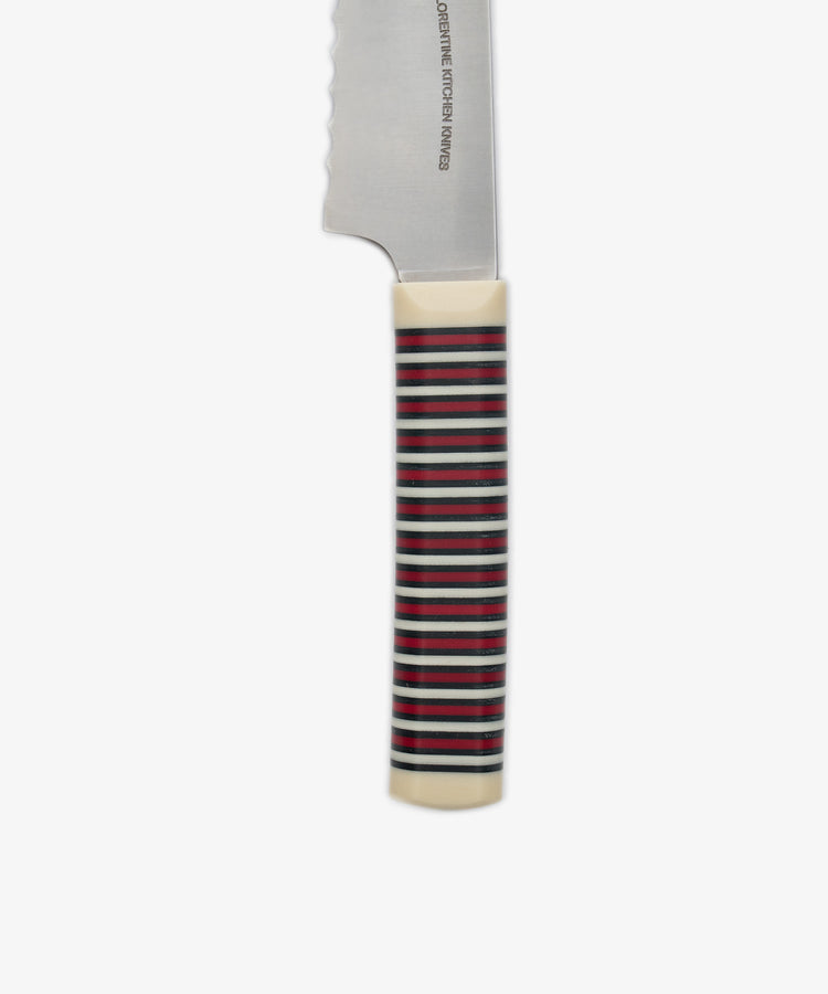 A close-up of the Bread Knife handle featuring horizontal red, black, and green stripes, with a visible section of the serrated blade set against a white background.
