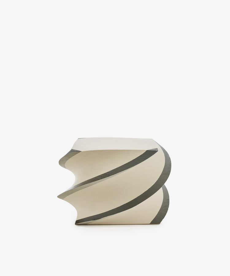 Introducing the Spiral Notepad: an off-white, sculptural stool with a twisted spiral design inspired by the product’s namesake, highlighted with gray accents and presented against a clean white backdrop.