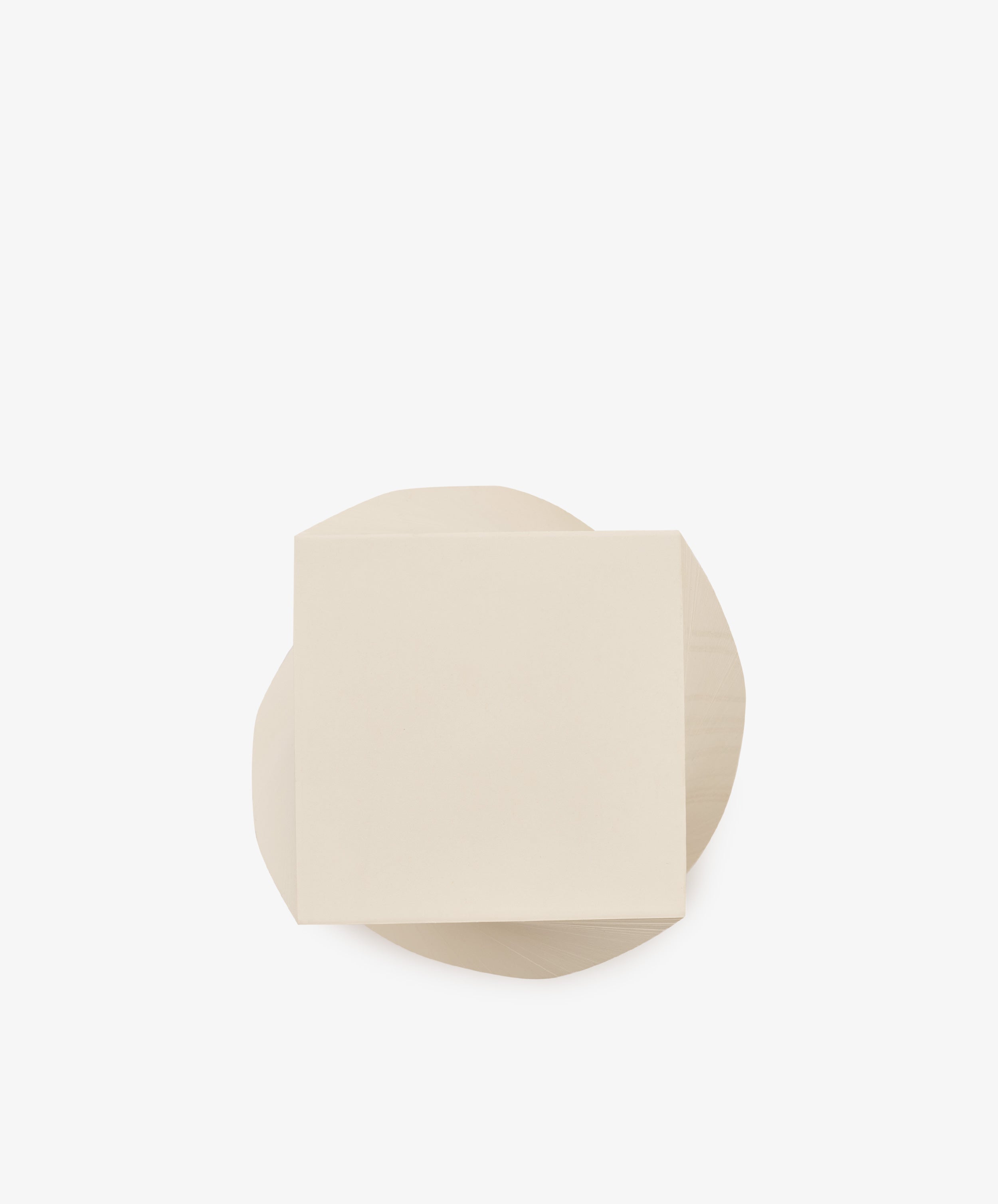 A beige square piece of paper, reminiscent of the Spiral Notepad, overlaps a beige irregularly shaped piece of paper on a plain white background.