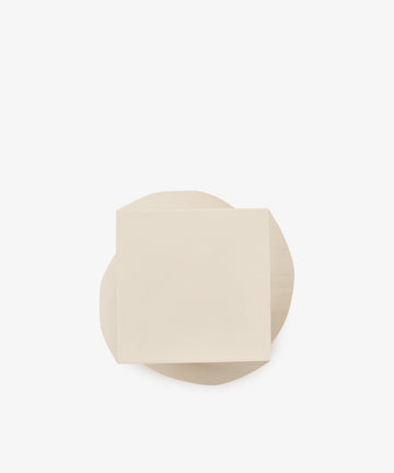 A beige square piece of paper, reminiscent of the Spiral Notepad, overlaps a beige irregularly shaped piece of paper on a plain white background.