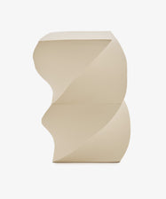 The Spiral Notepad features a beige sculptural design with geometric, spiral-like curves reminiscent of a helix, and a flat top and base, shown against a plain white background.