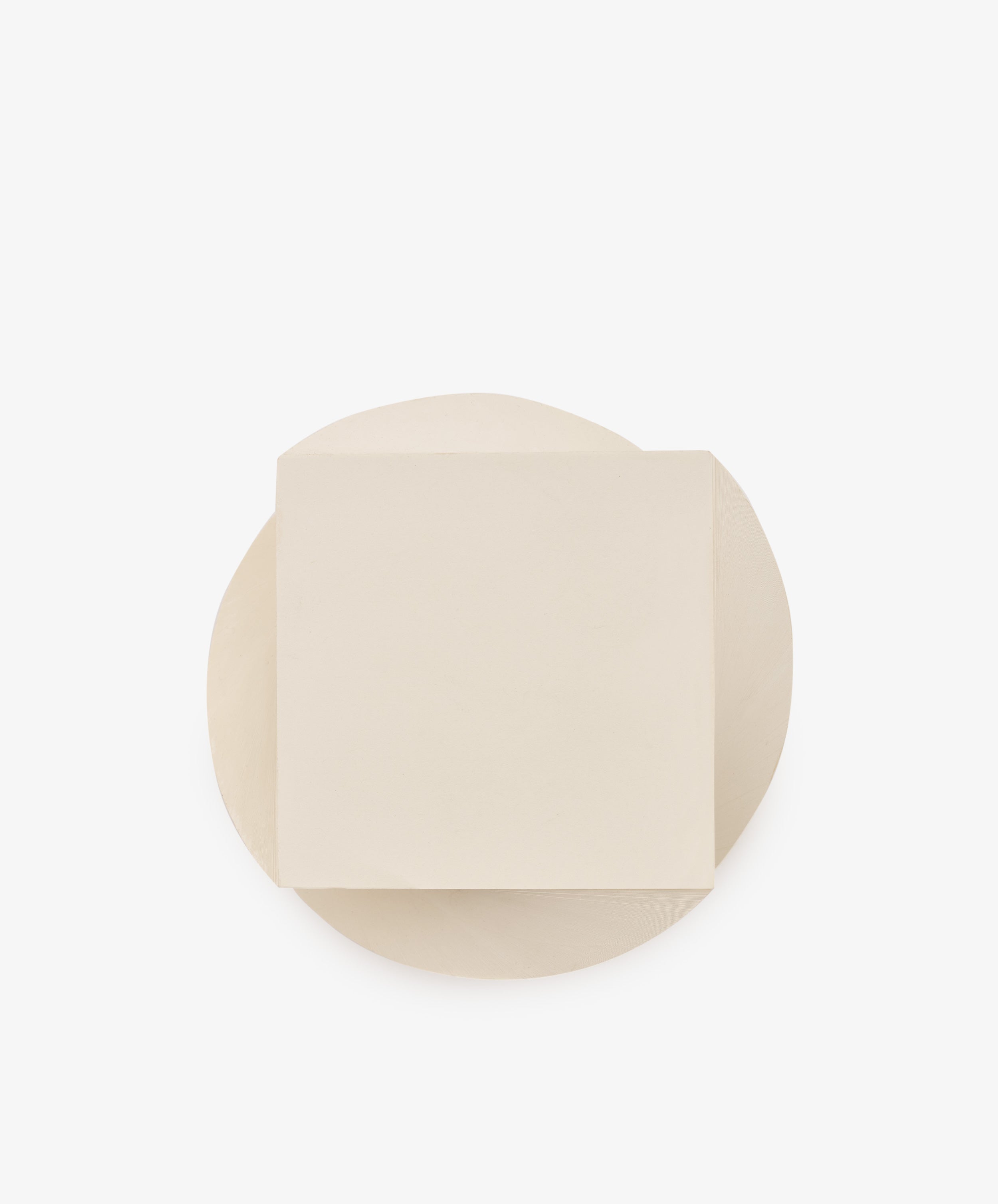 A round white Spiral Notepad, topped with a single square white Spiral Notepad, both set against a plain white background, creates a layered look reminiscent of a unique paper design.