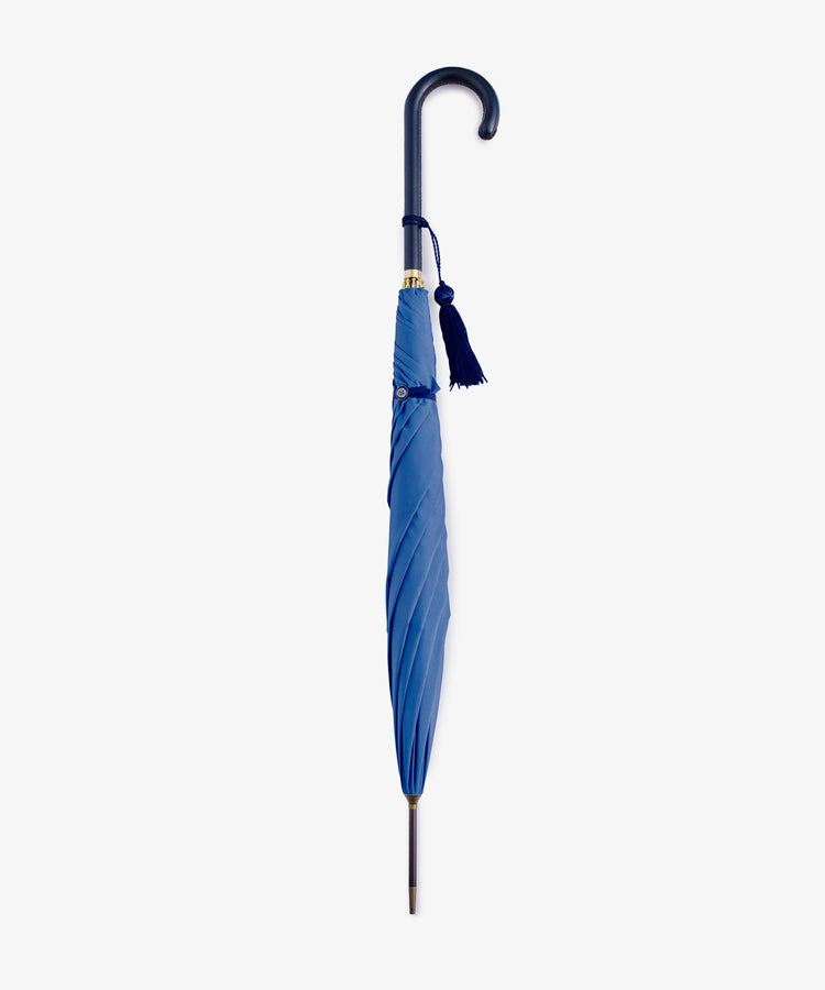The Victoria Ladies Umbrella features a closed blue canopy, curved handle, and matching blue tassel, displayed against a plain white background.