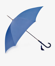 The Victoria Ladies Umbrella features a blue canopy, curved black handle, and decorative tassel, pictured against a plain white background.