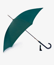 The Victoria Ladies Umbrella is a classic green English umbrella featuring a curved black leather handle and a small black tassel, shown against a plain white background.