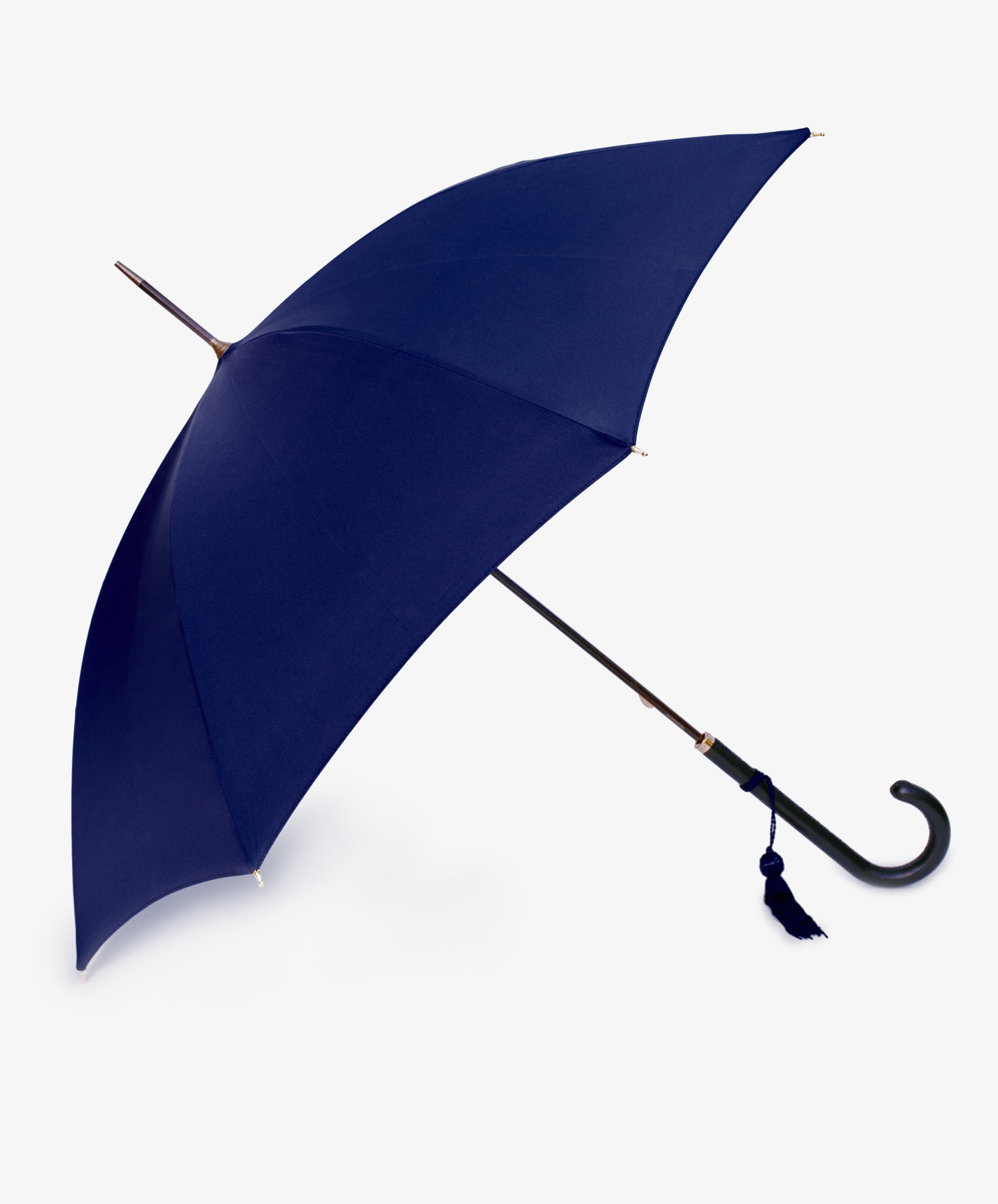The Victoria Ladies Umbrella features a navy canopy, elegant leather crook handle, and a small tassel, shown open against a white background.