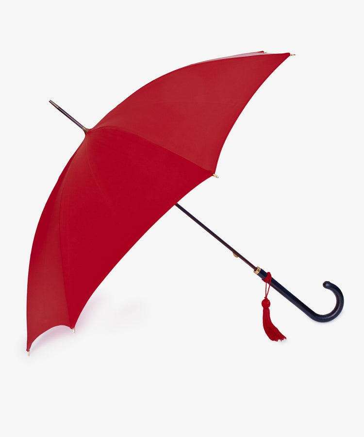 The Victoria Ladies Umbrella features a bold red canopy, curved black handle, and a decorative red tassel, shown against a white background.