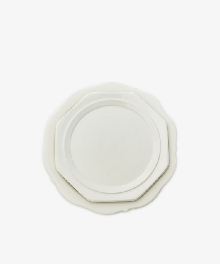 Two stacked Cirrus Scalloped Plates in classic creamware, with irregular edges, viewed from above on a plain white background.