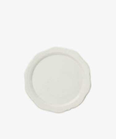 The Cirrus Scalloped Plate, crafted in elegant creamware, is shown from above on a white background.