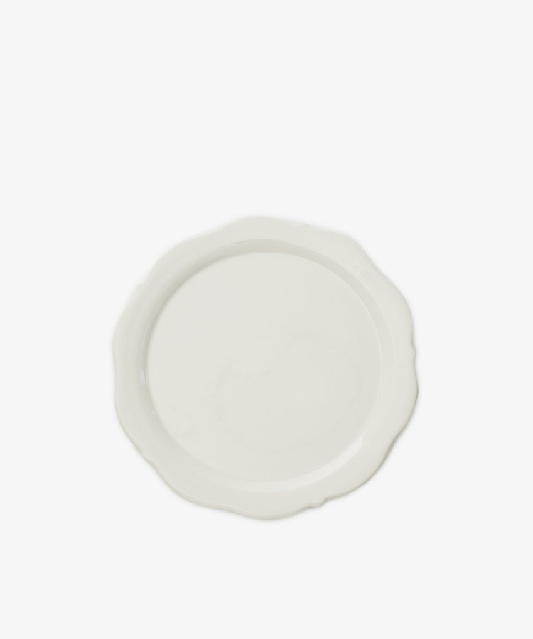 The Cirrus Scalloped Plate, crafted in elegant creamware, is shown from above on a white background.