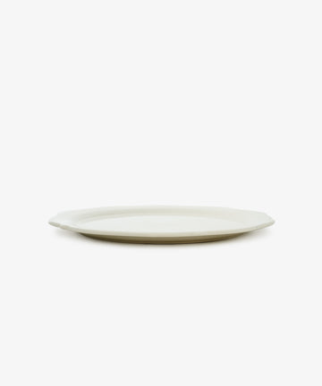 The Cirrus Scalloped Plate, white creamware with a scalloped edge, is shown in side view against a white background.