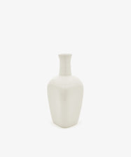 The Cirrus Bud Vase, crafted from white ceramic with a narrow neck and square base, is displayed against a plain white background in the elegant style of Frances Palmer.