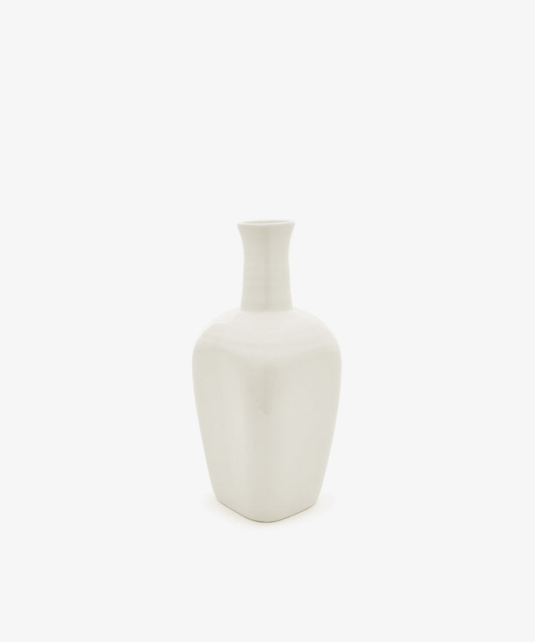 The Cirrus Bud Vase, crafted from white ceramic with a narrow neck and square base, is displayed against a plain white background in the elegant style of Frances Palmer.