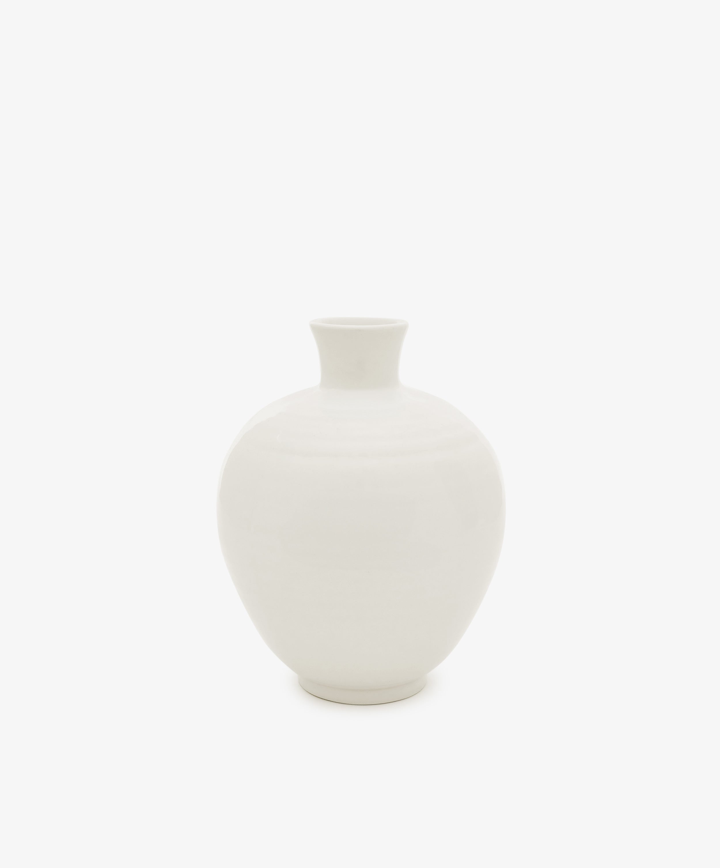 The Cirrus Bud Vase, featuring a white, round ceramic design with a narrow neck and wide body, is shown against a plain white background.