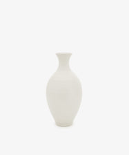 The Cirrus Bud Vase, featuring a rounded ceramic body and narrow neck in a minimalist white finish, is centered against a white background.