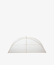 The Jacqueline Foodcover is a dome-shaped tent made of transparent mesh natural fiber with a simple frame, designed to protect food from insects.
