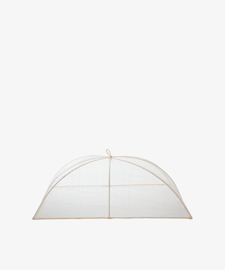The Jacqueline Foodcover is a dome-shaped tent made of transparent mesh natural fiber with a simple frame, designed to protect food from insects.
