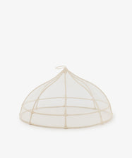 The Viola Foodcover is a handwoven mesh dome with a small loop handle, designed to protect food from insects—ideal for outdoor dining.