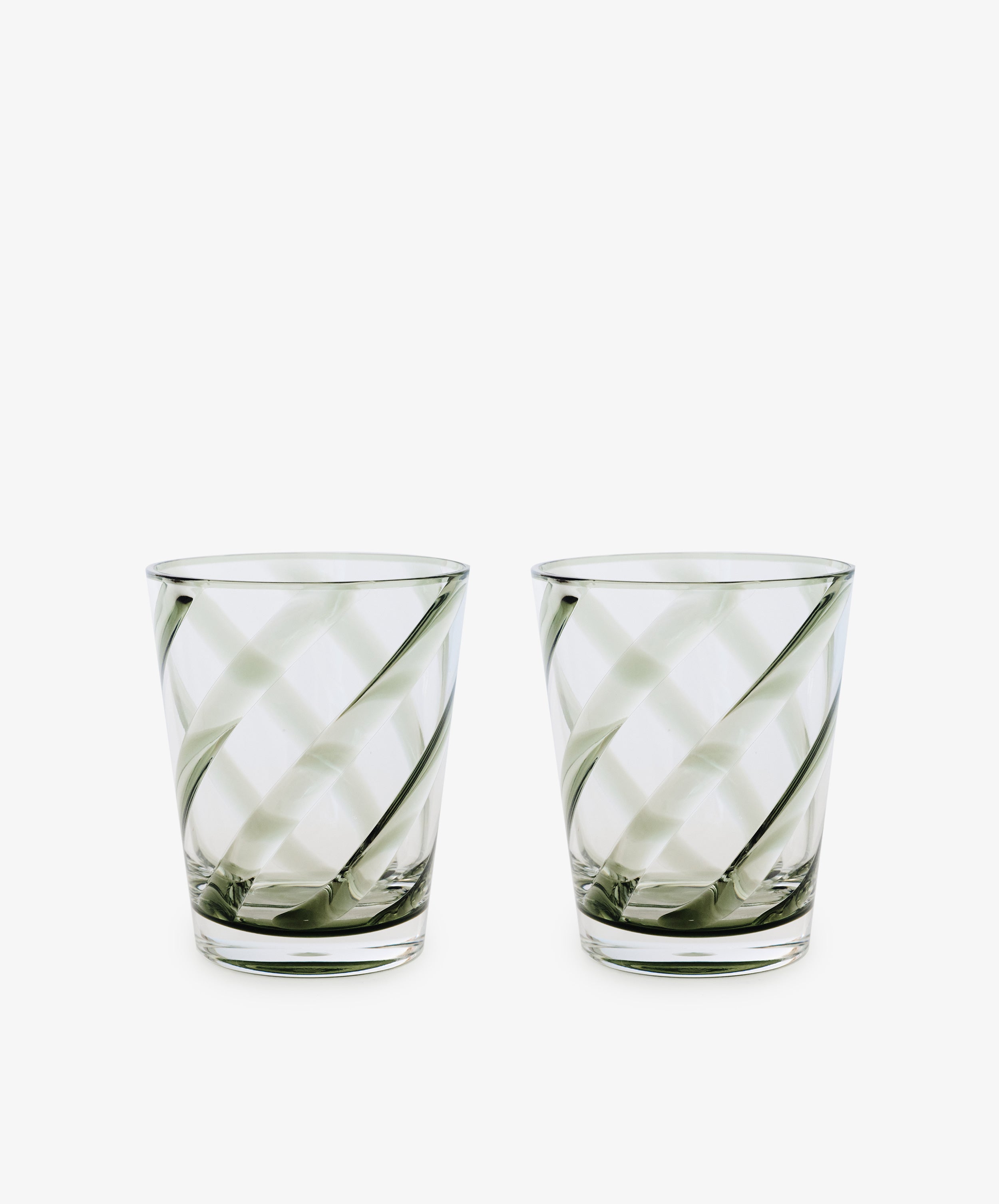 A set of four Vento Tumblers with clear glass and diagonal swirl patterns, inspired by Italian glassware, displayed side by side on a white background.