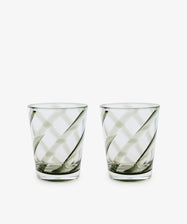 A set of four Vento Tumblers with clear glass and diagonal swirl patterns, inspired by Italian glassware, displayed side by side on a white background.