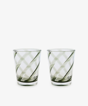 A set of four Vento Tumblers with clear glass and diagonal swirl patterns, inspired by Italian glassware, displayed side by side on a white background.