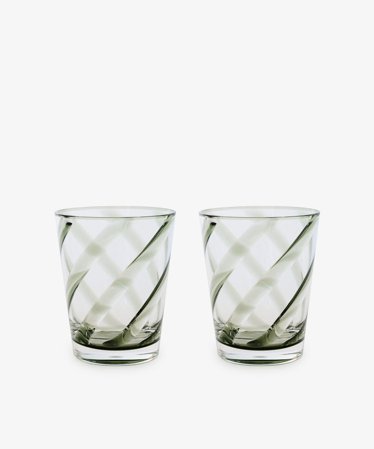 A set of four Vento Tumblers with clear glass and diagonal swirl patterns, inspired by Italian glassware, displayed side by side on a white background.