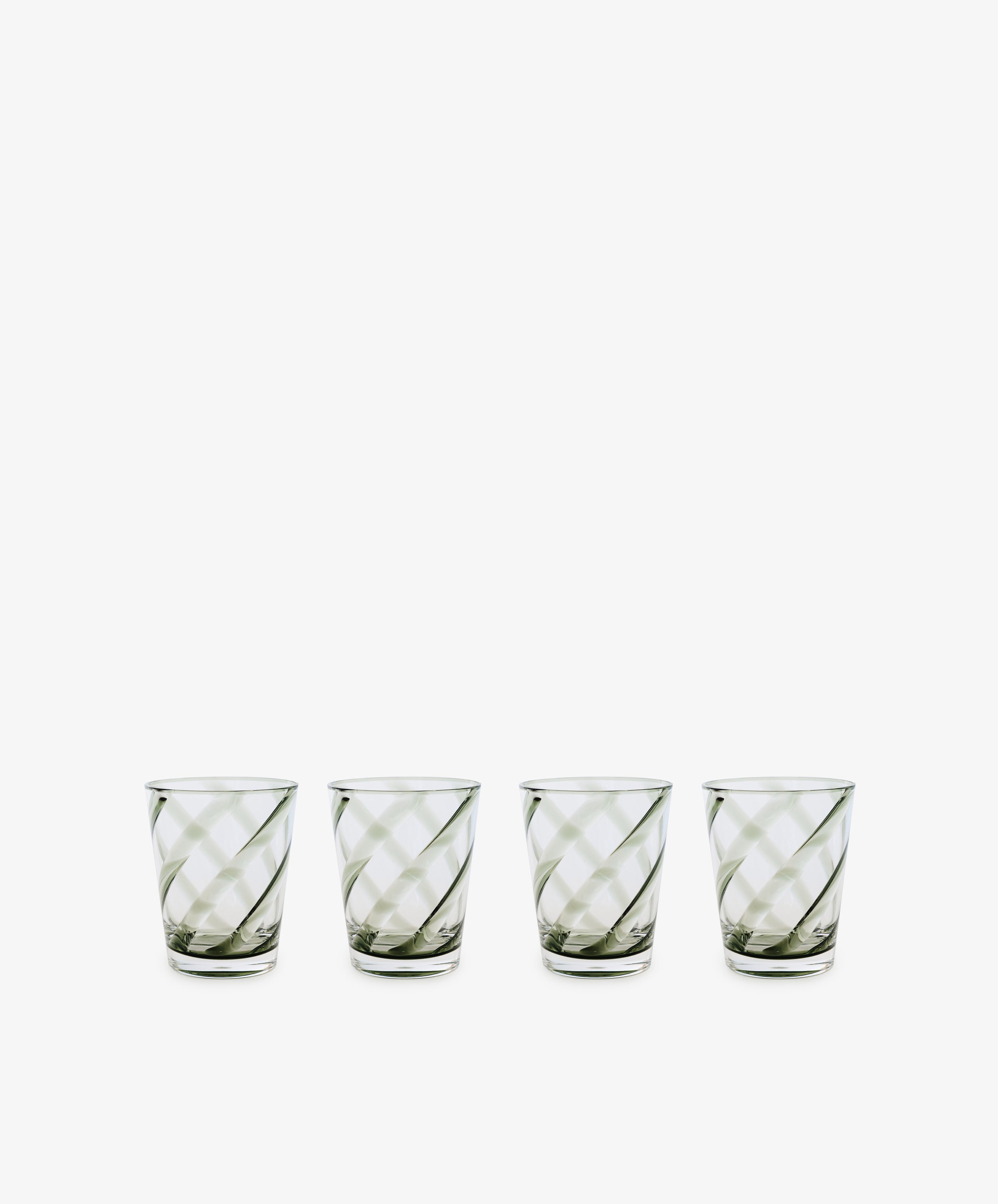 A set of four Vento Tumblers, inspired by mid-century Italian glassware and featuring diagonal stripes, is arranged in a row on a white background.