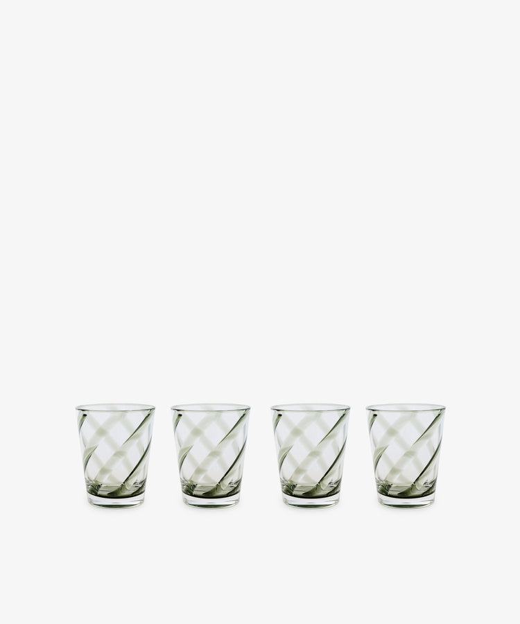 A set of four Vento Tumblers, inspired by mid-century Italian glassware and featuring diagonal stripes, is arranged in a row on a white background.