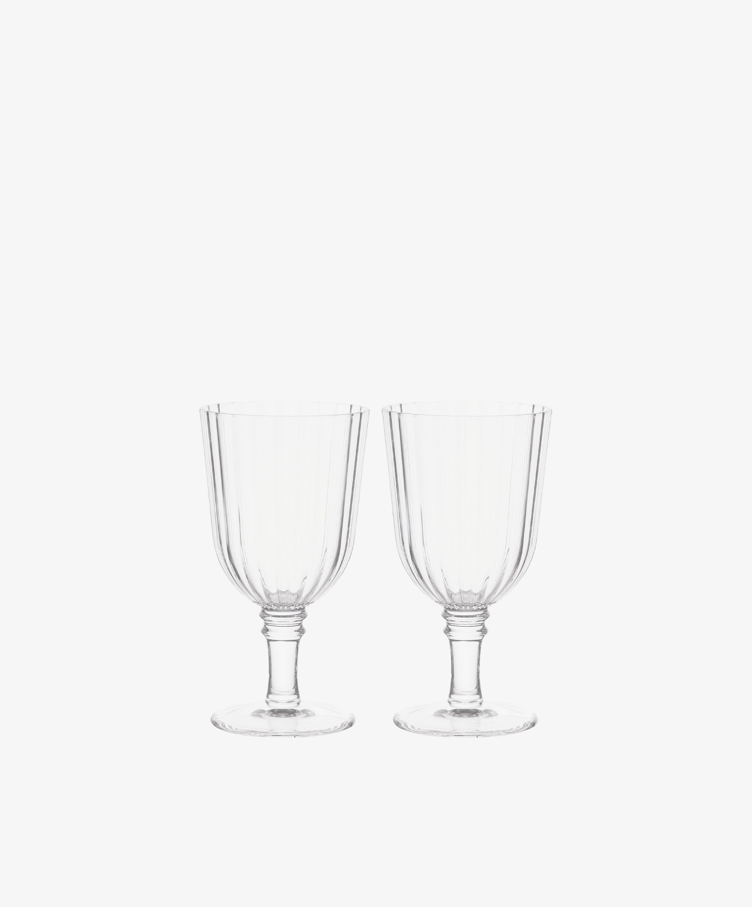 The Fresco Goblet, Set of 4 features clear stemmed glassware with vertical ribbed patterns—elegant tableware ideal for festive gatherings and holiday celebrations.